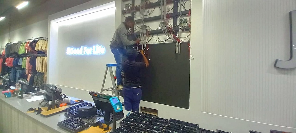 Technician configuring a retail digital display