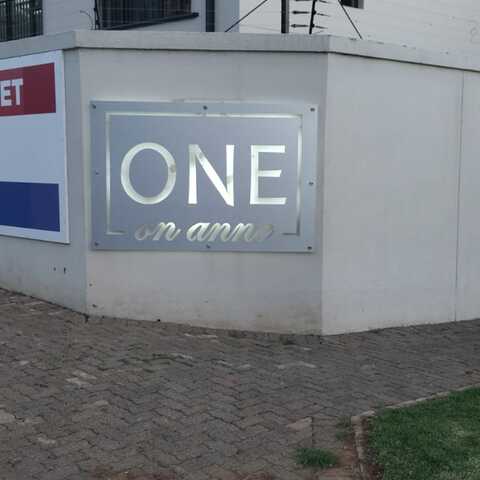 ONE outdoor illuminated wall sign