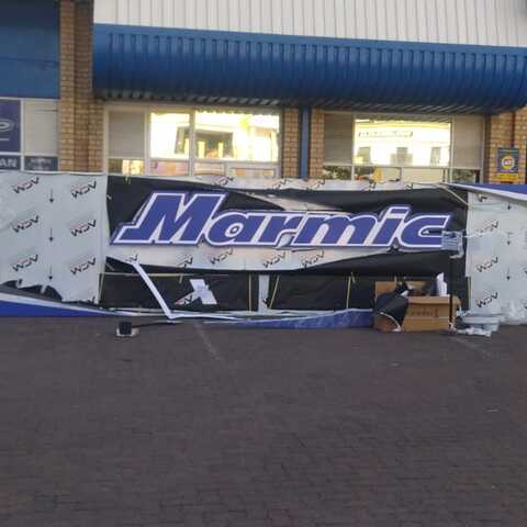 Fabricated Marinta shop sign during installation