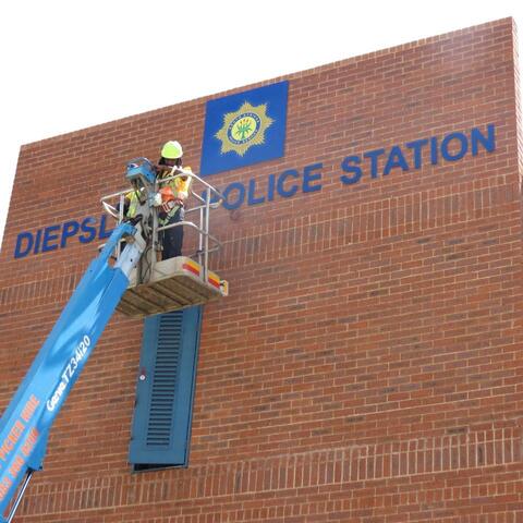 Police station lettering installed with a cherry picker
