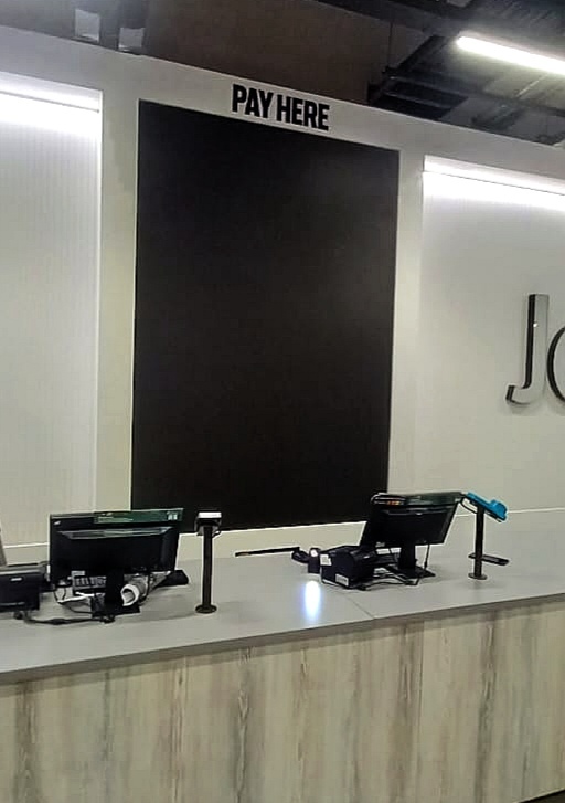 Completed twin digital menu screens above a service counter